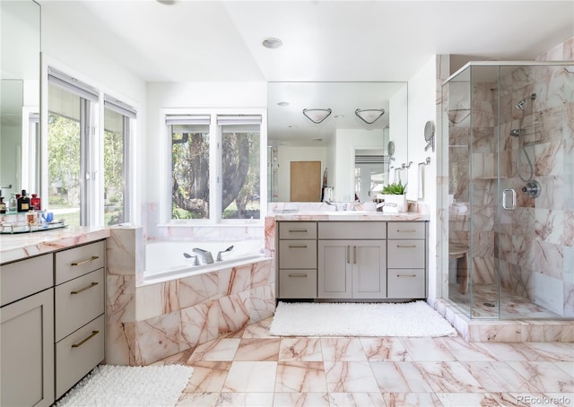 full bath featuring a garden tub, marble finish floor, vanity, and a shower stall