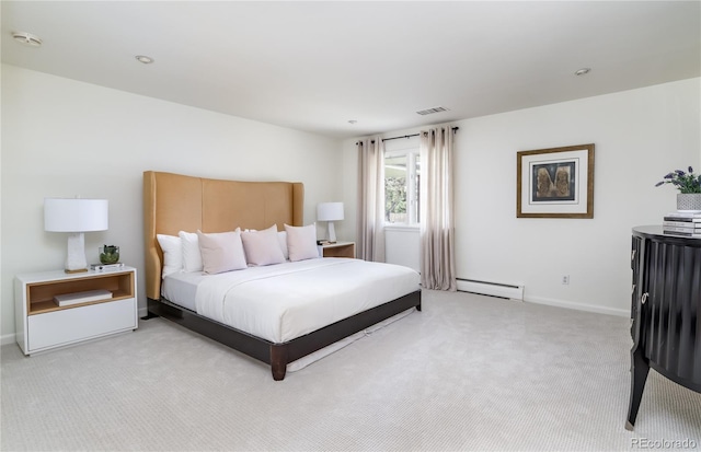 bedroom featuring baseboards, a baseboard heating unit, light carpet, and visible vents