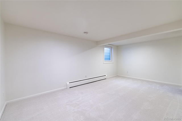 empty room featuring baseboards, light colored carpet, and a baseboard radiator