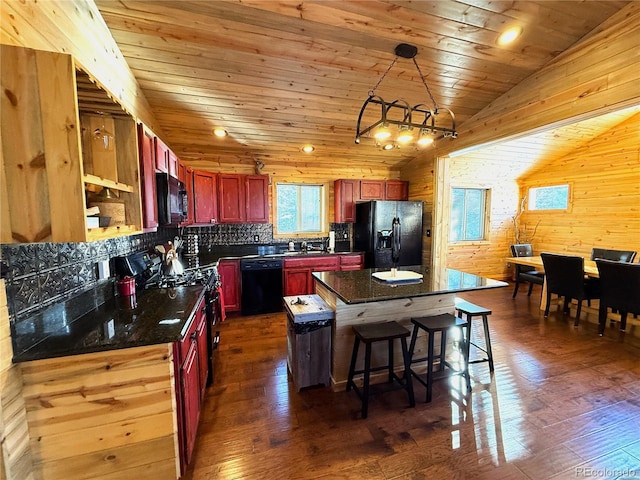 kitchen featuring vaulted ceiling, black appliances, wood ceiling, a kitchen island, and backsplash