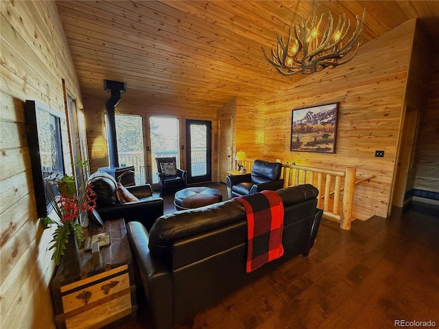 living room with wood ceiling, a chandelier, vaulted ceiling, and a wood stove