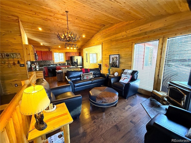 living room featuring wood ceiling, vaulted ceiling, a chandelier, a wealth of natural light, and dark hardwood / wood-style floors