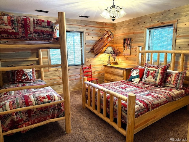 carpeted bedroom with a notable chandelier