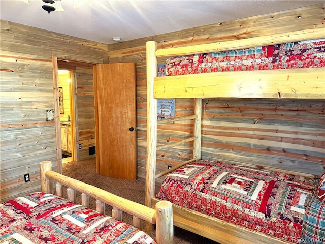 bedroom with wood walls and carpet flooring