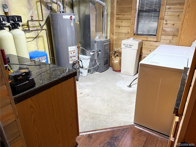 interior space featuring heating unit, water heater, and independent washer and dryer