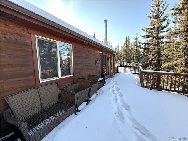 view of snow covered exterior featuring a deck