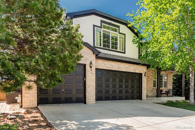 7852 Solstice Way, Castle Rock, CO 80108 - view of front facade featuring concrete driveway, brick siding, and an attached garage