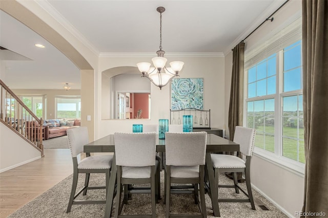 7852 Solstice Way, Castle Rock, CO 80108 - dining room with a chandelier, baseboards, stairway, ornamental molding, and wood finished floors