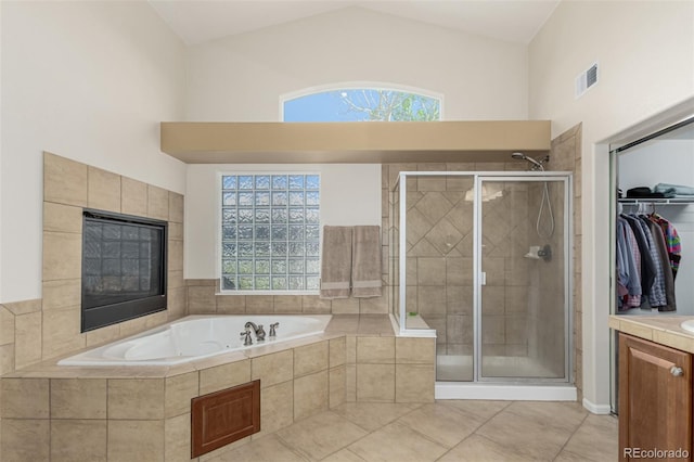 7852 Solstice Way, Castle Rock, CO 80108 - bathroom with a bath, a shower stall, plenty of natural light, and high vaulted ceiling