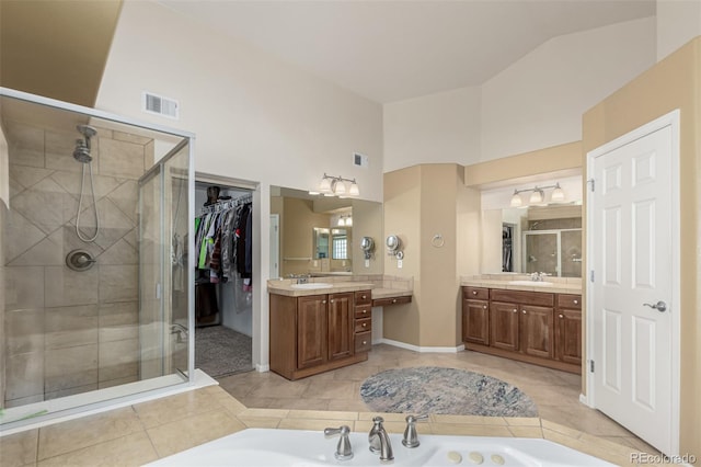 7852 Solstice Way, Castle Rock, CO 80108 - full bath featuring a stall shower, vanity, a bath, tile patterned flooring, and high vaulted ceiling