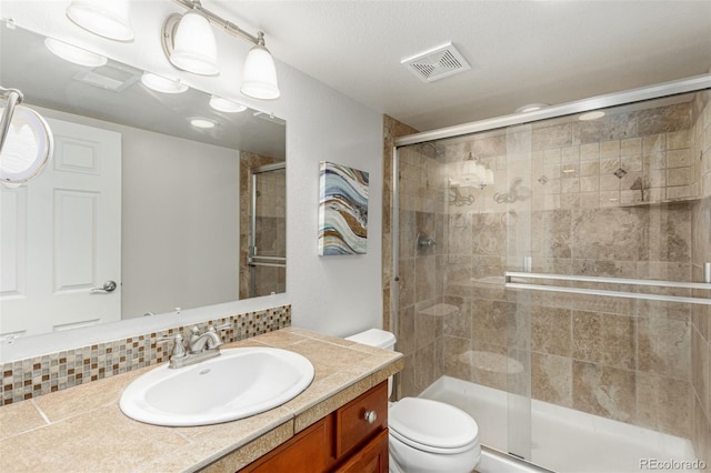7852 Solstice Way, Castle Rock, CO 80108 - bathroom featuring toilet, vanity, a stall shower, and tasteful backsplash