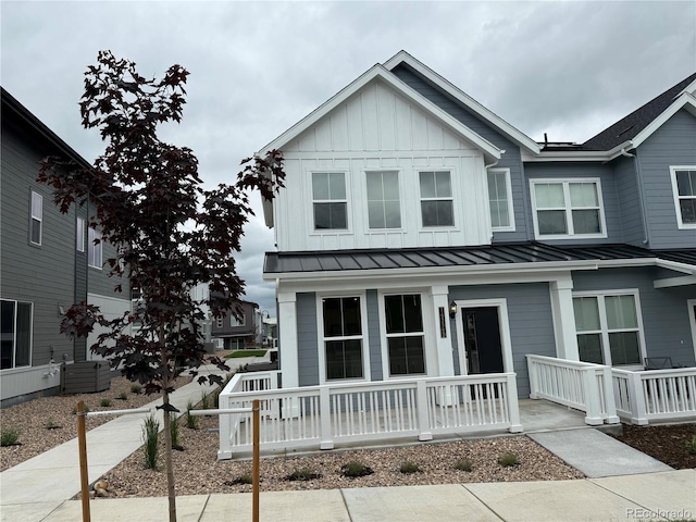 14556 W 91st Ave Unit D, Arvada, CO 80005 - view of front facade with a porch, a standing seam roof, board and batten siding, and a metal roof