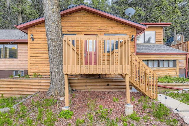 8758 S Murphy Gulch Rd, Littleton, CO 80127 - back of property featuring a shingled roof, stairs, a deck, and log veneer siding