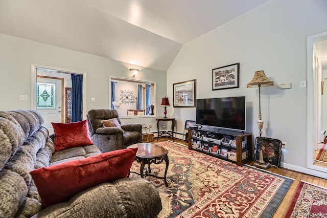 8758 S Murphy Gulch Rd, Littleton, CO 80127 - living room featuring wood finished floors, vaulted ceiling, and baseboard heating