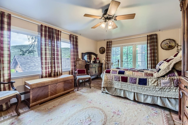 8758 S Murphy Gulch Rd, Littleton, CO 80127 - bedroom with wood finished floors, crown molding, and ceiling fan