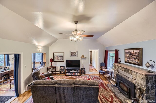 8758 S Murphy Gulch Rd, Littleton, CO 80127 - living area with light wood finished floors, lofted ceiling, plenty of natural light, a ceiling fan, and a baseboard heating unit