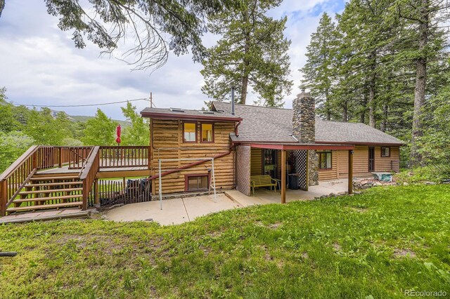 8758 S Murphy Gulch Rd, Littleton, CO 80127 - back of property with a patio area, a wooden deck, a chimney, stairway, and a lawn