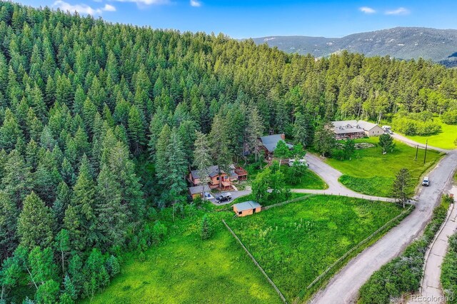 8758 S Murphy Gulch Rd, Littleton, CO 80127 - view of property location with a forest and a mountain backdrop