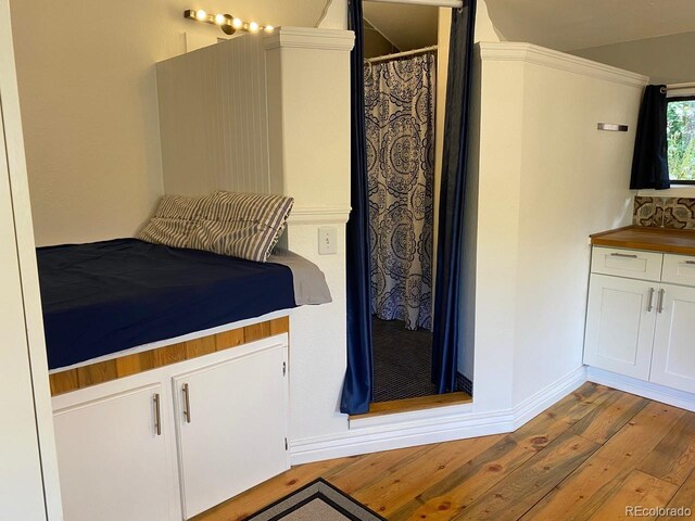 8758 S Murphy Gulch Rd, Littleton, CO 80127 - bedroom featuring hardwood / wood-style floors and baseboards