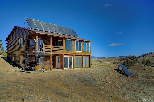 back of house with a mountain view