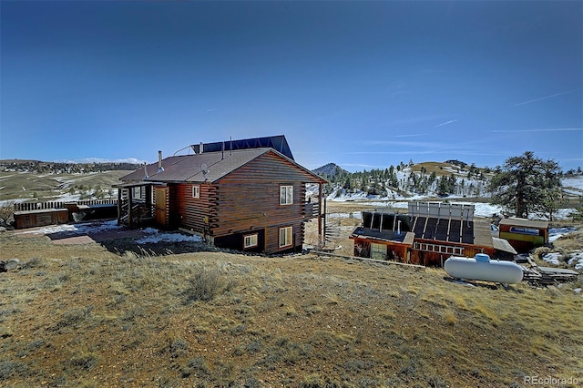 snow covered property featuring a mountain view