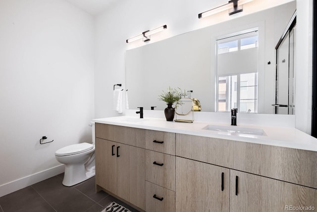 5227 N Eliot St, Denver, CO 80221 - full bathroom with double vanity and tile patterned flooring