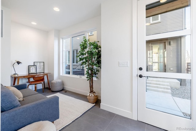 5227 N Eliot St, Denver, CO 80221 - living room featuring dark tile patterned flooring and recessed lighting