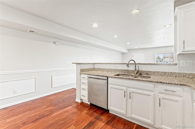 1461 S Danube Way Unit 104, Aurora, CO 80017 - kitchen with dark wood-style flooring, a sink, dishwasher, white cabinetry, and visible vents