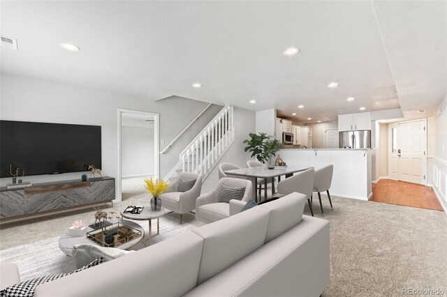 1461 S Danube Way Unit 104, Aurora, CO 80017 - living area with recessed lighting, light carpet, and stairway