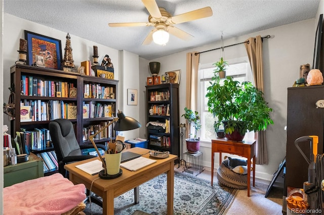 home office with ceiling fan and a textured ceiling