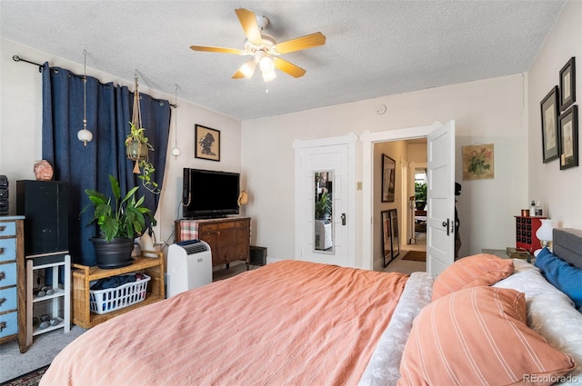 bedroom with ceiling fan and a textured ceiling