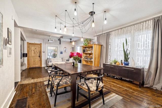 dining space with dark wood-type flooring