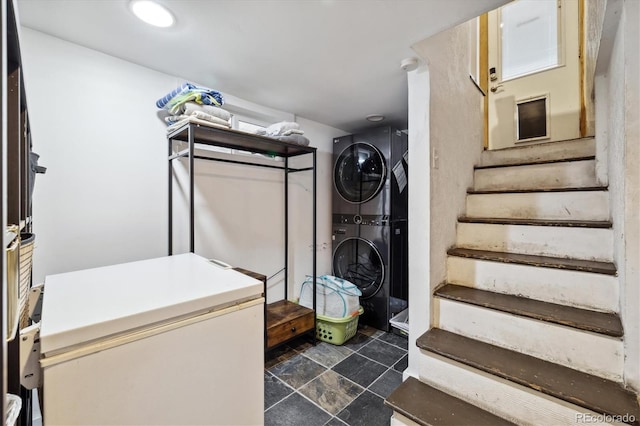 clothes washing area featuring stacked washer and dryer