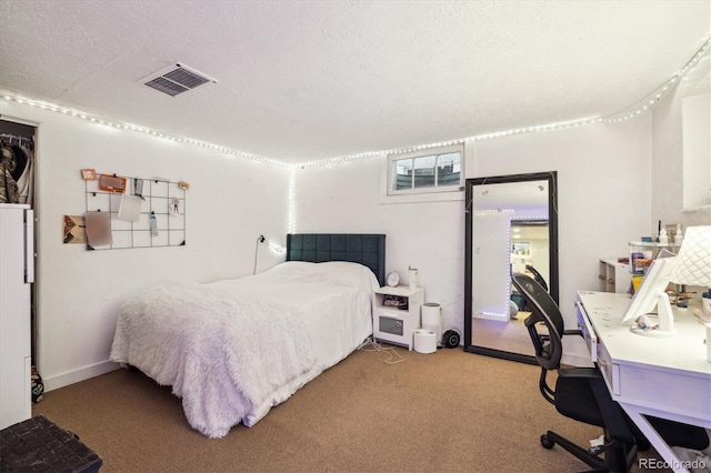 bedroom featuring light carpet and a textured ceiling