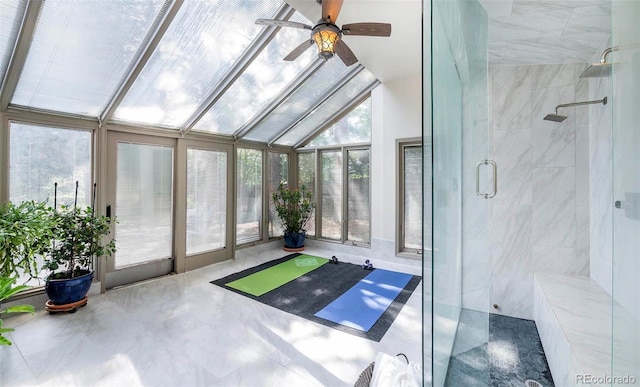 unfurnished sunroom with vaulted ceiling, a wealth of natural light, and ceiling fan