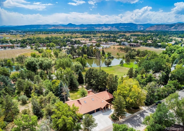 drone / aerial view with a water and mountain view