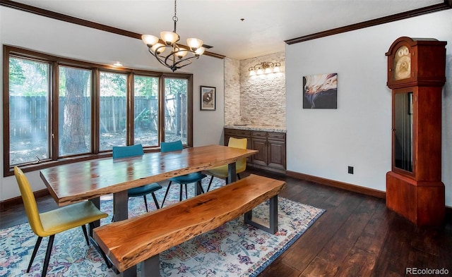 dining area with a chandelier, crown molding, baseboards, and dark wood-style floors