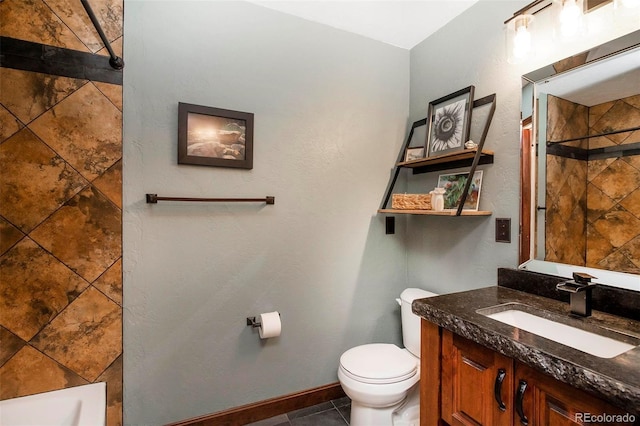 full bath with toilet, a tile shower, baseboards, tile patterned flooring, and vanity