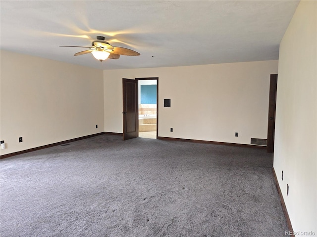empty room featuring dark colored carpet, baseboards, a ceiling fan, and visible vents