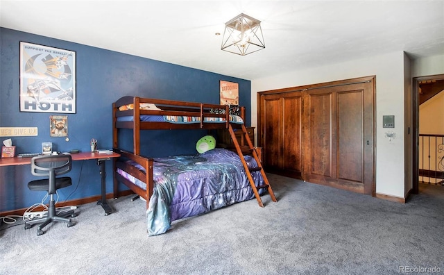 carpeted bedroom featuring baseboards