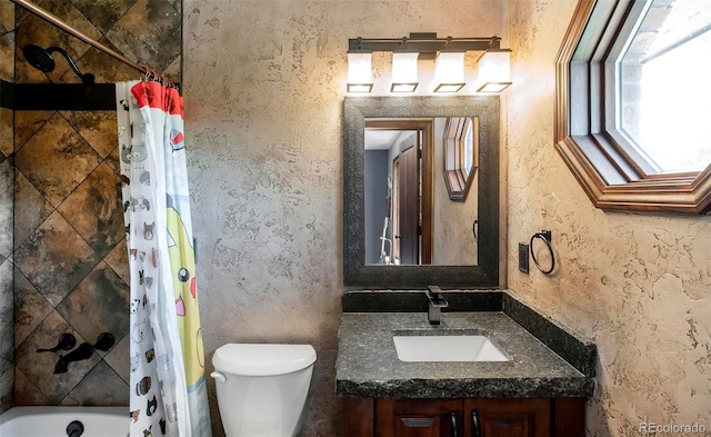 full bath featuring toilet, vanity, and shower / bath combo with shower curtain