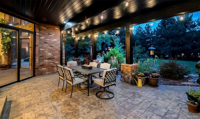 patio at night featuring outdoor dining area