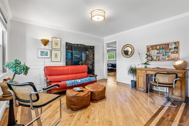 living room with hardwood / wood-style flooring and ornamental molding