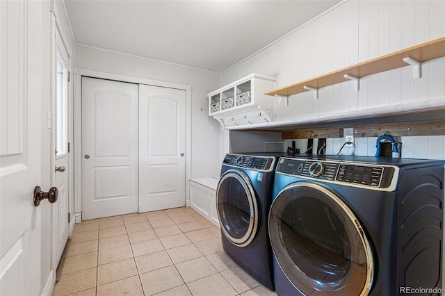 laundry area featuring separate washer and dryer and light tile patterned floors