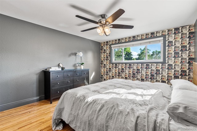 bedroom with ceiling fan and light wood-type flooring