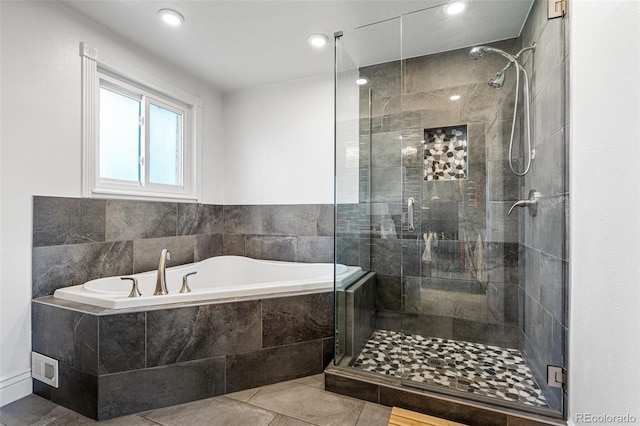 bathroom with tile patterned flooring and separate shower and tub