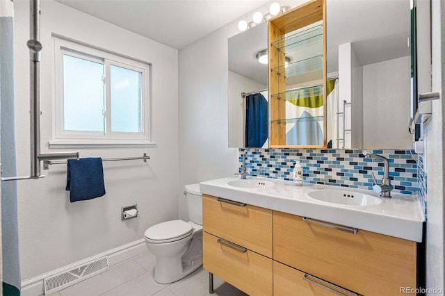 bathroom featuring backsplash, vanity, a shower with curtain, tile patterned floors, and toilet