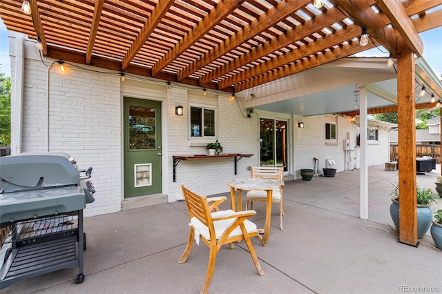 view of patio / terrace with area for grilling and a pergola