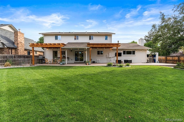 rear view of house with a yard, a patio area, and a pergola