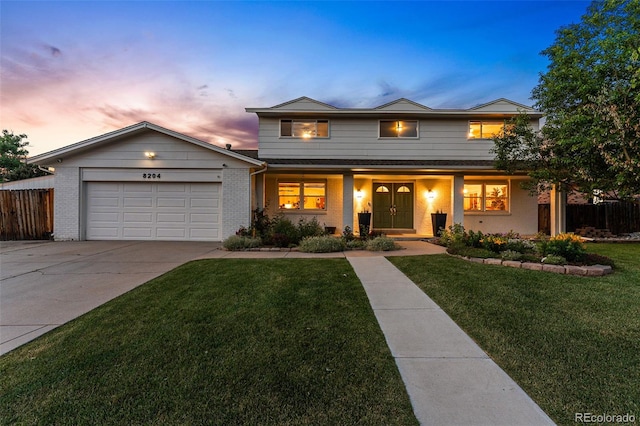 view of front of home featuring a yard and a garage